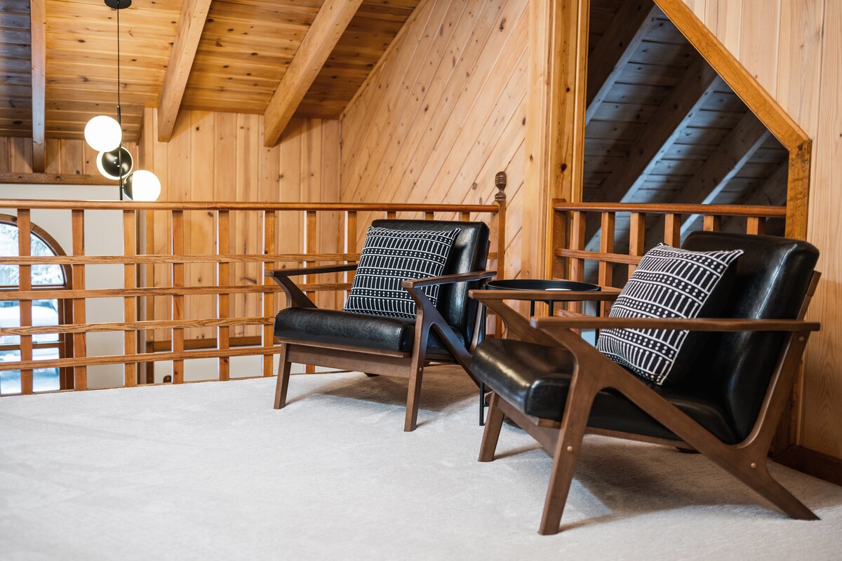 Loft reading nook with two mid-century chairs